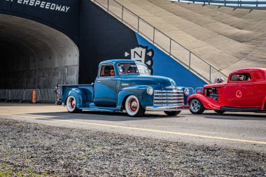 Lebanon, TN - May 14, 2022: Wide angle front corner view of a 1949 Chevrolet Stepside Pickup Truck driving on a road leaving a local car show.