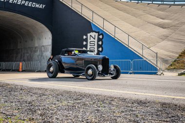 Lebanon, TN - May 14, 2022: Wide angle front corner view of a 1932 Ford Model B Highboy Roadster driving on a road leaving a local car show.