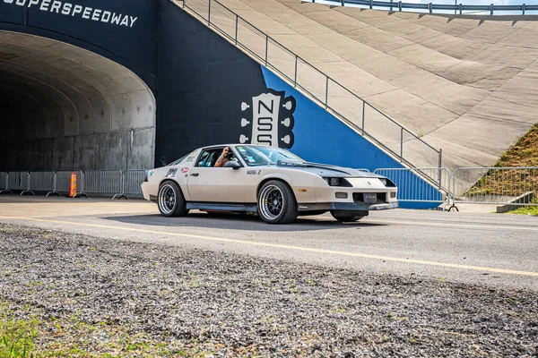 Lebanon, TN - May 14, 2022: Wide angle front corner view of a 1986 Chevrolet Camaro Z28 Coupe driving on a road leaving a local car show.