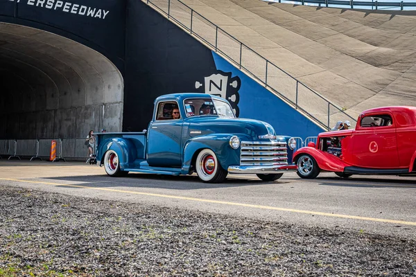 Lebanon, TN - May 14, 2022: Wide angle front corner view of a 1949 Chevrolet Stepside Pickup Truck driving on a road leaving a local car show.