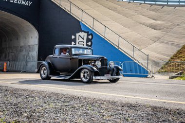 Lebanon, TN - May 14, 2022: Wide angle front corner view of a 1932 Ford Model B 5 Window Coupe driving on a road leaving a local car show.