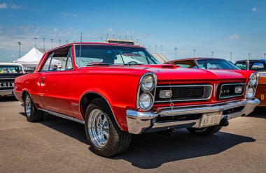 Lebanon, TN - May 13, 2022: Low perspective front corner view of a 1965 Pontiac LeMans GTO Hardtop Coupe at a local car show.
