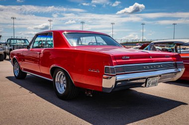 Lebanon, TN - May 13, 2022: Low perspective rear corner view of a 1965 Pontiac LeMans GTO Hardtop Coupe at a local car show.