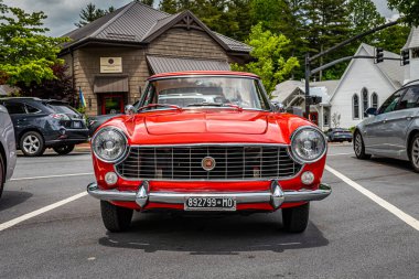 Highlands, NC - June 10, 2022: Low perspective front view of a 1966 Fiat 1500 Spider Hardtop Coupe at a local car show.