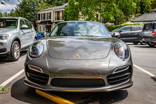 Highlands, NC - June 10, 2022: Low perspective front view of a 2014 Porsche 911 Turbo S Coupe at a local car show.