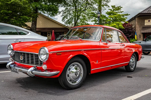 Highlands, NC - June 10, 2022: Low perspective front corner view of a 1966 Fiat 1500 Spider Hardtop Coupe at a local car show.