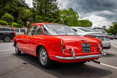 Highlands, NC - June 10, 2022:  Low perspective rear corner view of a 1966 Fiat 1500 Spider Hardtop Coupe at a local car show.