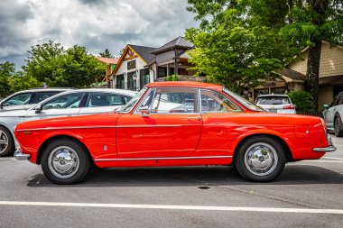 Highlands, NC - June 10, 2022: Low perspective side view of a 1966 Fiat 1500 Spider Hardtop Coupe at a local car show.