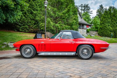 Highlands, NC - June 10, 2022: Low perspective side view of a 1966 Chevrolet Corvette Stingray Convertible at a local car show.
