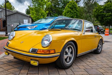Highlands, NC - June 10, 2022: Low perspective front corner view of a 1973 Porsche 911 S Targa Coupe at a local car show.