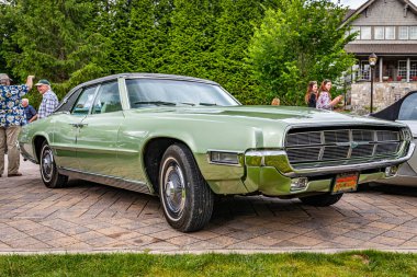 Highlands, NC - June 10, 2022: Low perspective front corner view of a 1969 Ford Thunderbird Landau Sedan at a local car show.