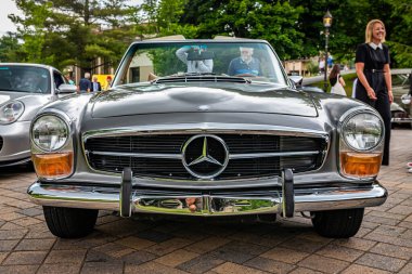 Highlands, NC - June 10, 2022: Low perspective front view of a 1969 Mercedes Benz 280 SL Convertible Coupe at a local car show.