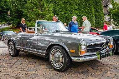 Highlands, NC - June 10, 2022: Low perspective front corner view of a 1969 Mercedes Benz 280 SL Convertible Coupe at a local car show.