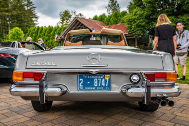 Highlands, NC - June 10, 2022: Low perspective rear view of a 1969 Mercedes Benz 280 SL Convertible Coupe at a local car show.