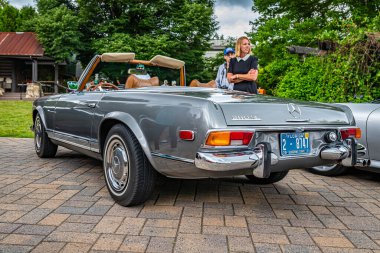 Highlands, NC - June 10, 2022: Low perspective rear corner view of a 1969 Mercedes Benz 280 SL Convertible Coupe at a local car show.