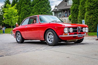 Highlands, NC - June 10, 2022: Low perspective front corner view of a 1970 Alfa Romeo 1750 GTV  leaving a local car show.