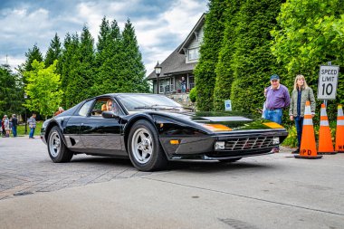 Highlands, NC - June 10, 2022: Low perspective front corner view of a 1980 Ferrari 512 BB Coupe leaving a local car show.