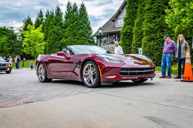 Highlands, NC - June 10, 2022: Low perspective front corner view of a 2016 Chevrolet Corvette Stingray Convertible leaving a local car show.