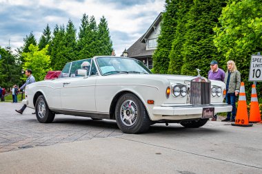 Highlands, NC - June 10, 2022: Low perspective front corner view of a 1989 Rolls-Royce Corniche II Convertible leaving a local car show.