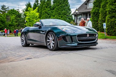 Highlands, NC - June 10, 2022: Low perspective front corner view of a 2014 Jaguar F-Type V8 S Convertible leaving a local car show.