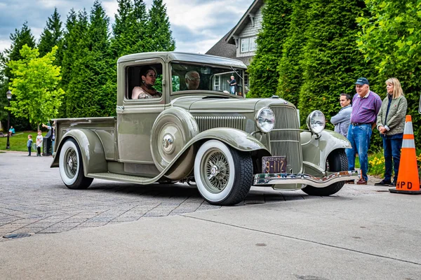 Highlands, NC - June 10, 2022: Low perspective front corner view of a 1933 Ford Model B Pickup truck leaving a local car show.