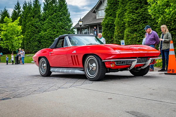 Highlands, NC - June 10, 2022: Low perspective front corner view of a 1966 Chevrolet Corvette Stingray Convertible leaving a local car show.