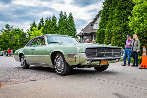 Highlands, NC - June 10, 2022: Low perspective front corner view of a 1969 Ford Thunderbird Landau Sedan leaving a local car show.