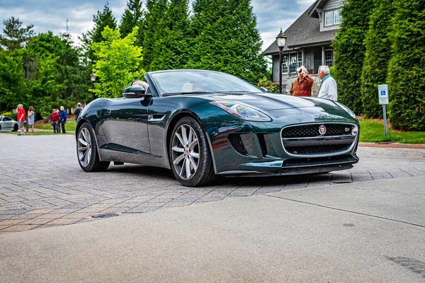 Highlands, NC - June 10, 2022: Low perspective front corner view of a 2014 Jaguar F-Type V8 S Convertible leaving a local car show.