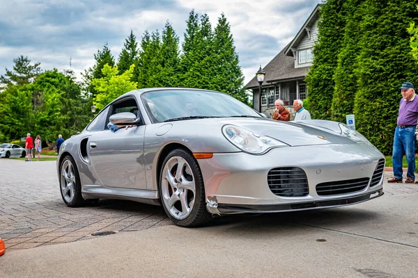 Highlands, NC - June 10, 2022: Low perspective front corner view of a 2002 Porsche 911 Turbo Tiptronic Coupe leaving a local car show.