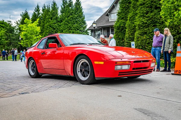 Highlands, NC - June 10, 2022: Low perspective front corner view of a 1986 Porsche 944 Turbo Hardtop Coupe leaving a local car show.