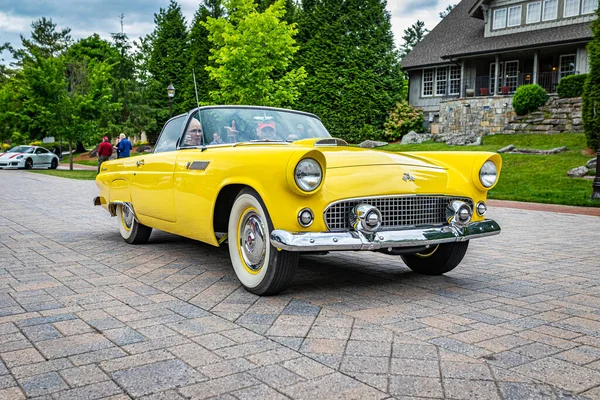 Highlands, NC - June 10, 2022: Low perspective front corner view of a 1955 Ford Thunderbird Convertible leaving a local car show.