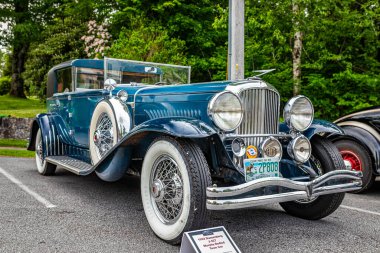 Highlands, NC - June 11, 2022: Low perspective front corner view of a 1933 Duesenberg J-427 Murphy Bodied Town Car at a local car show.