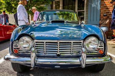 Highlands, NC - June 11, 2022: Low perspective front view of a 1963 Triumph TR4 Convertible at a local car show.