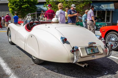 Highlands, NC - June 11, 2022: Low perspective rear corner view of a 1954 Jaguar XK120 Open Two Seater Roadster at a local car show.
