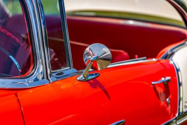 Statesboro, GA - May 17, 2014: Shallow depth of field closeup of the driver rearview mirror and vent window detail on a 1955 Chevrolet BelAir.