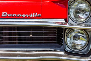 Statesboro, GA - May 17, 2014: Shallow depth of field closeup of the headlight assembly details of a 1967 Pontiac Bonneville.