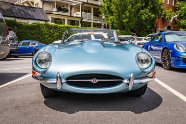 Highlands, NC - June 11, 2022: Low perspective front view of a 1965 Jaguar E Type Series 1 4.2 Roadster at a local car show.