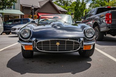 Highlands, NC - June 11, 2022: Low perspective front view of a 1975 Jaguar E-Type V12 Roadster at a local car show.