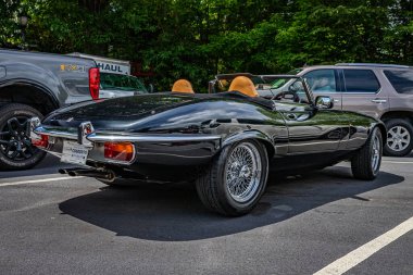 Highlands, NC - June 11, 2022: Low perspective rear corner view of a 1975 Jaguar E-Type V12 Roadster at a local car show.