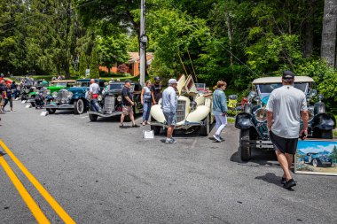 Highlands, NC - June 10, 2022: Wide angle view of  car enthusiasts and parked cars at a local car show.