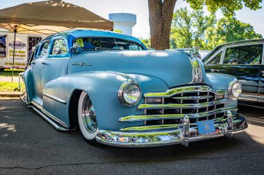 Falcon Heights, MN - June 17, 2022: Low perspective front corner view of a 1948 Pontiac Silver Streak 8 4 Door Sedan at a local car show.