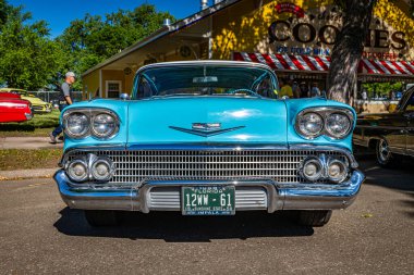Falcon Heights, MN - June 17, 2022: Low perspective front view of a 1958 Chevrolet Impala Coupe at a local car show.