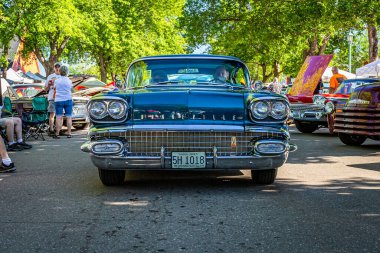 Falcon Heights, MN - June 17, 2022: Wide angle low perspective front view of a 1958 Pontiac Bonneville 2 Door Hardtop at a local car show.