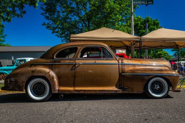 Falcon Heights, MN - June 17, 2022: Low perspective side view of a 1941 Oldsmobile Series 60 Club Coupe at a local car show.