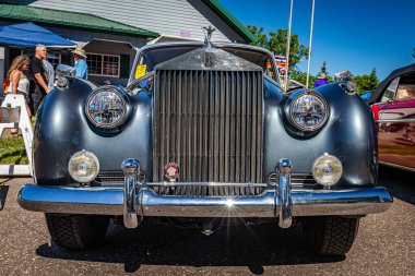Falcon Heights, MN - June 17, 2022: Low perspective front view of a 1960 Rolls Royce Silver Cloud II Sedan at a local car show.