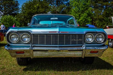 Savannah, GA - April 21, 2018: Low perspective front view of a 1964 Chevrolet Impala Hardtop Coupe at a local car show.