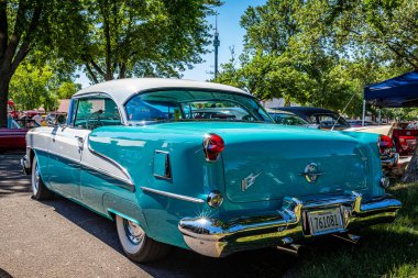 Falcon Heights, MN - June 17, 2022: Low perspective rear corner view of a 1955 Oldsmobile Super 88 Holiday Coupe at a local car show.