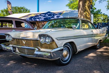 Falcon Heights, MN - June 17, 2022: Low perspective front corner view of a 1958 Plymouth Fury Golden Commando Coupe at a local car show.
