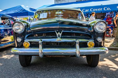 Falcon Heights, MN - June 17, 2022: Low perspective front view of a 1953 Willys Aero Ace Hardtop Coupe at a local car show.