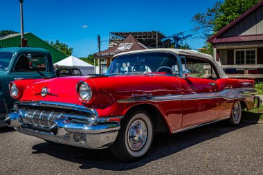 Falcon Heights, MN - June 17, 2022: Low perspective front corner view of a 1957 Pontiac Star Chief Convertible at a local car show.